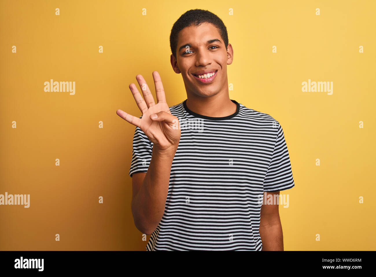 Young handsome arab man wearing navy striped t-shirt over isolated ...