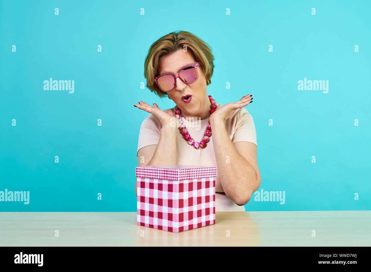 Funny excited old woman. A woman in age was very happy to receive gifts.  holding opened present box isolated over Stock Photo - Alamy