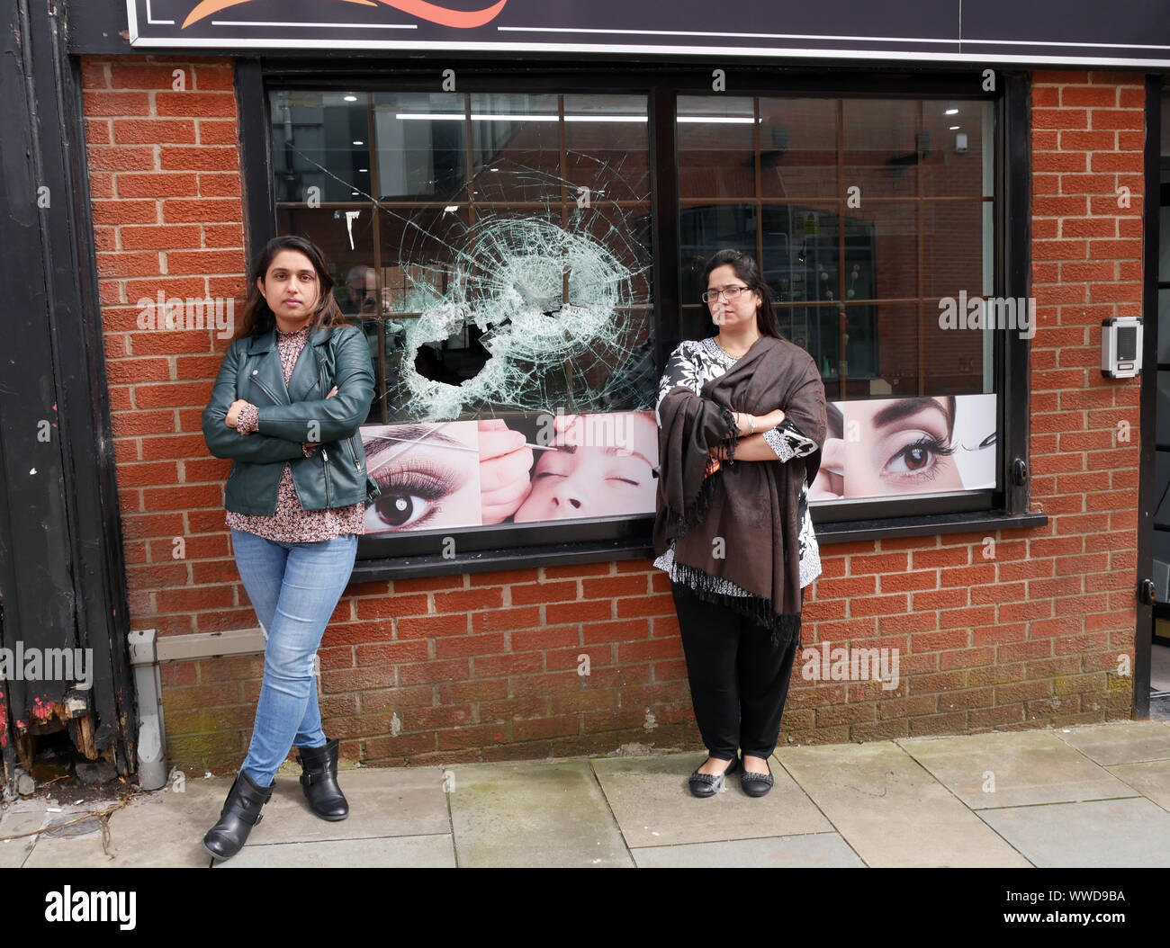 Asian vandalised shop window in Northern England UK Stock Photo