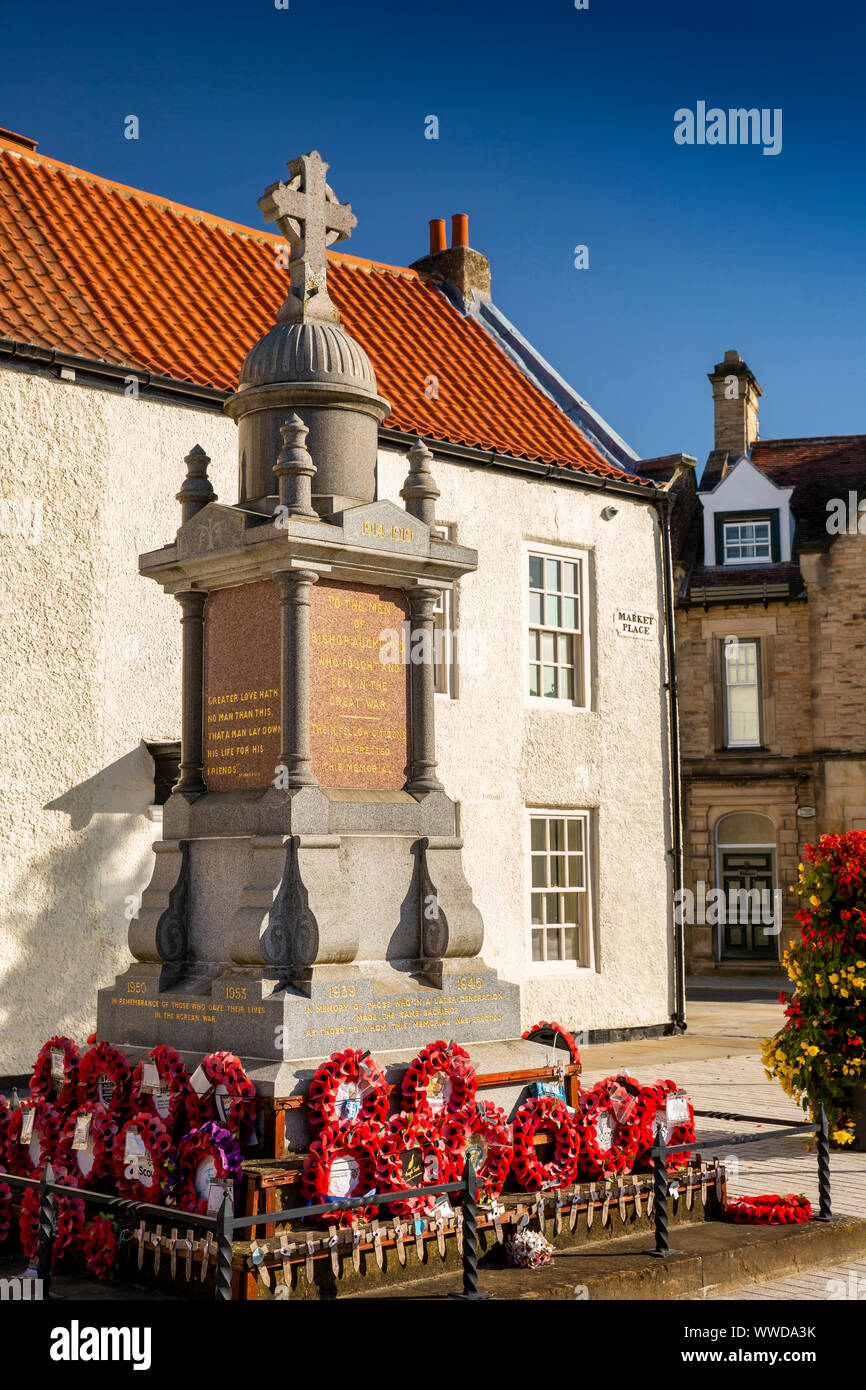 UK, County Durham, Bishop Auckland, Market Place, poppy wreaths at War Memorial Stock Photo