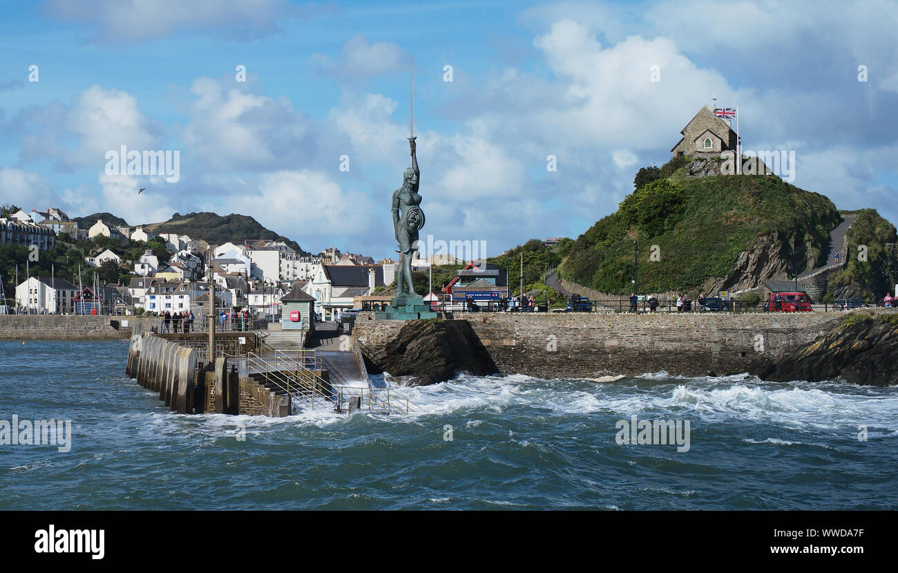 The sculpture called Verity by artist Damien Hurst stands looking out to sea at the entrance to Ilfracombe Harbour, Devon, UK. Stock Photo