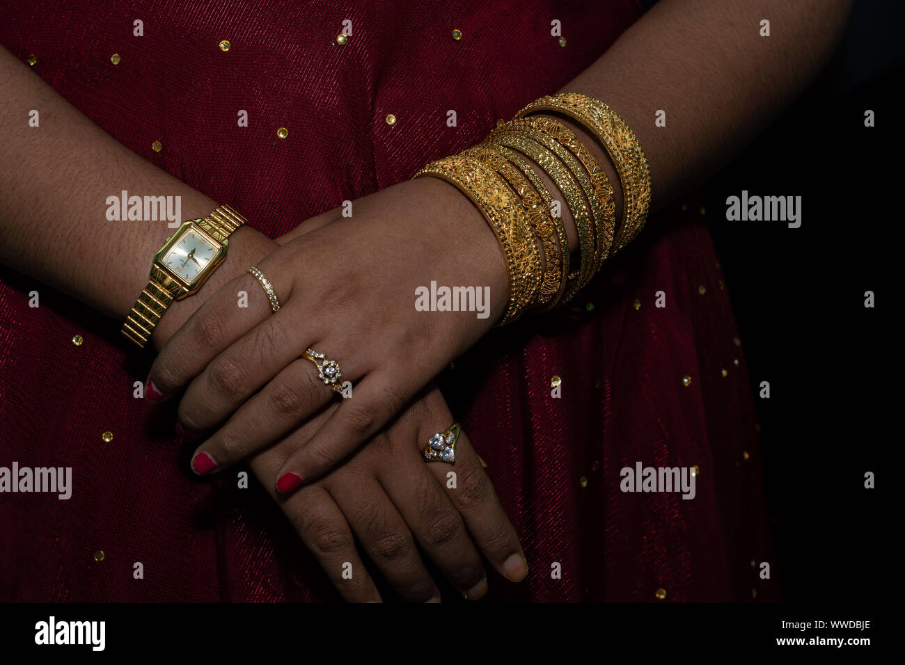 Bangladeshi style Bride fashion gold jewelry bangles hand bracelets watch on beautiful hand of wedding woman lady Stock Photo