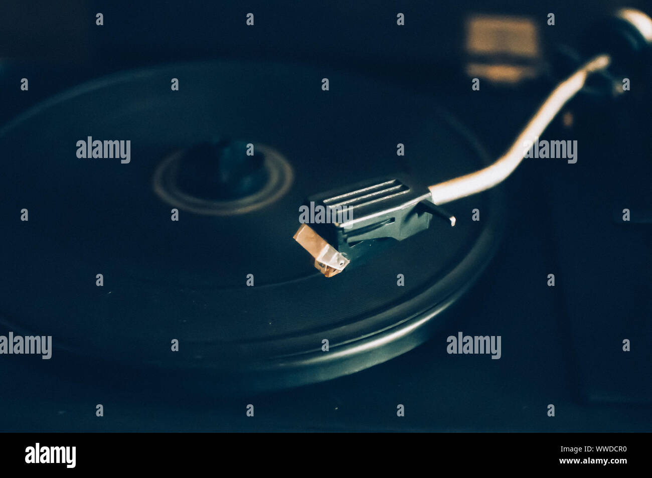 Vinyl record player on a sunset background over the city lights. Sound technology for DJs to mix