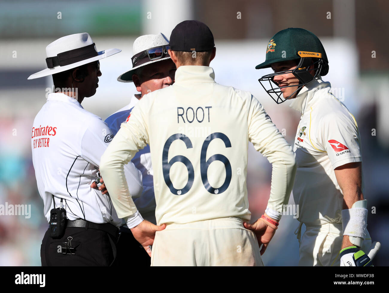 Umpire's Kumar Dharmasena (left) and Marais Erasmus (centre left) speak to England's Joe Root (back to camera) and Australia's Tim Paine during day four of the fifth test match at The Kia Oval, London. Stock Photo