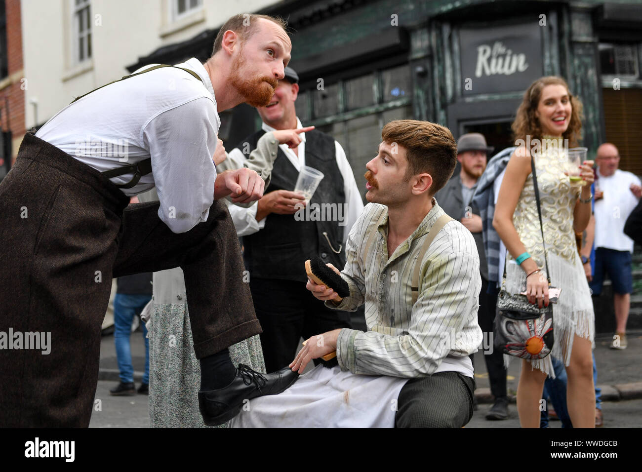 Actors recreate scenes on the streets of Digbeth during the Peaky Blinders Festival, in Birmingham. Stock Photo