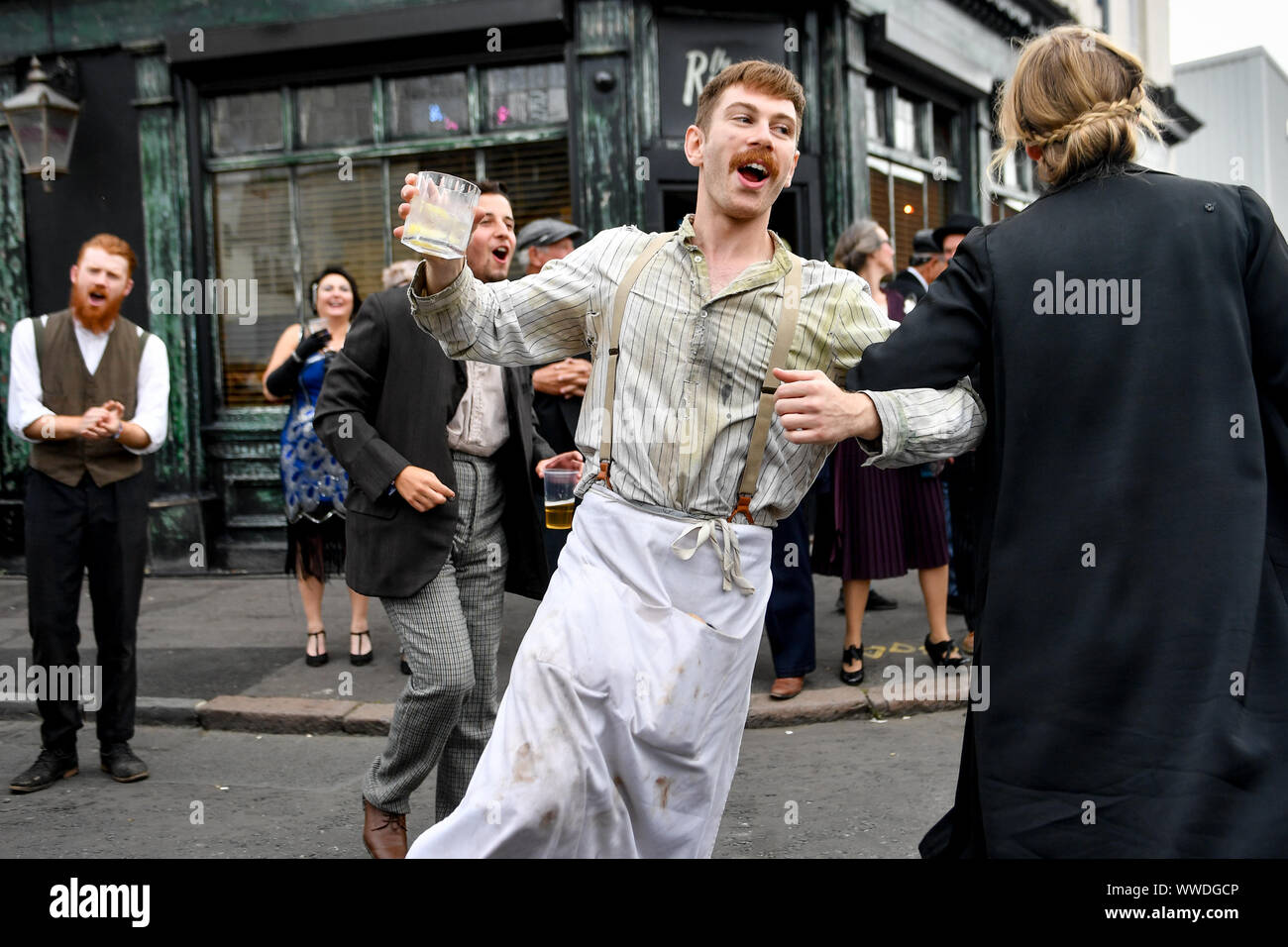 Actors recreate scenes on the streets of Digbeth during the Peaky Blinders Festival, in Birmingham. Stock Photo