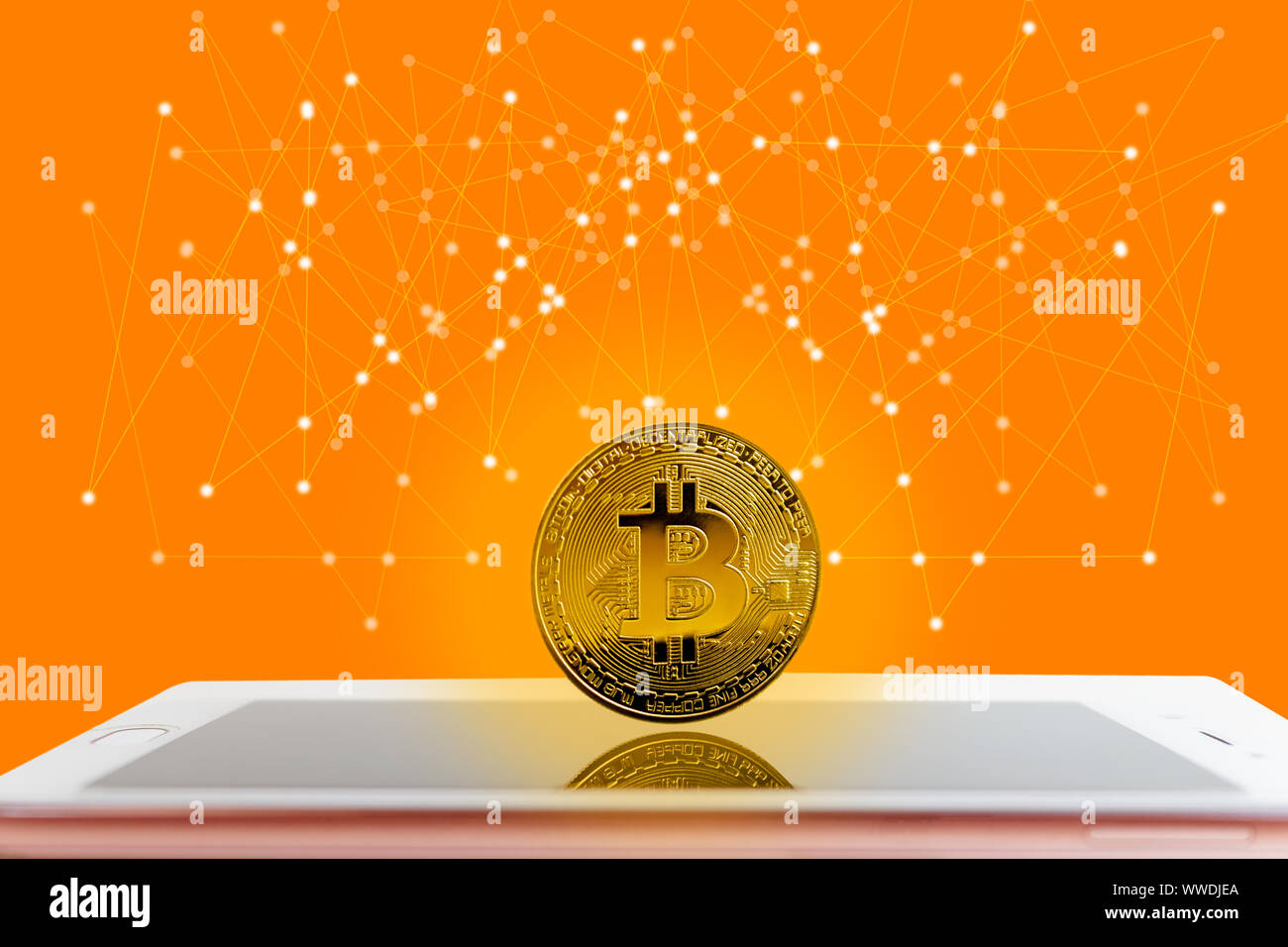 Golden digital bitcoins Currency stand on smartphone Digital Network and society orange tone ...