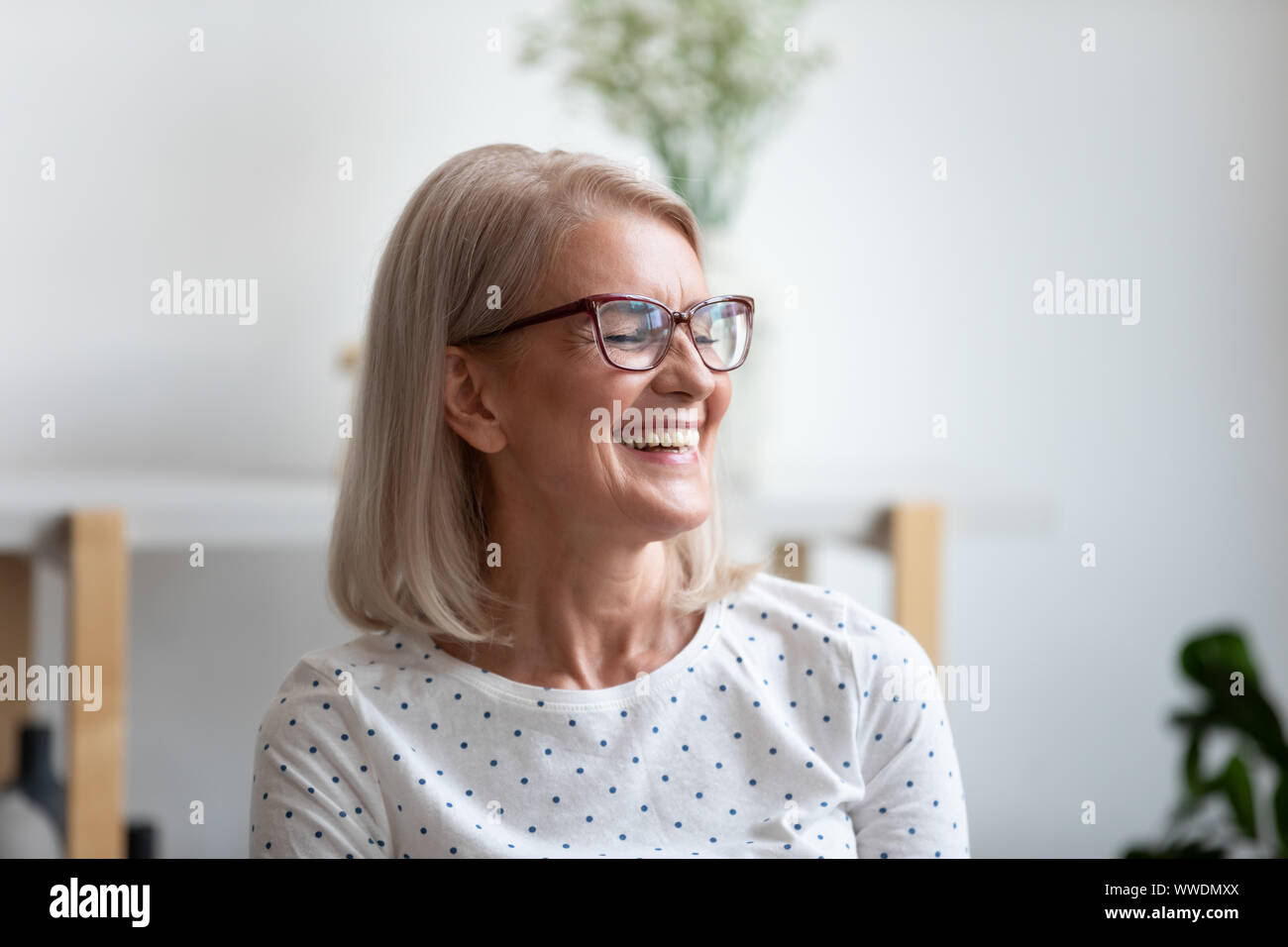 Close up happy beautiful mature woman laughing at funny joke Stock Photo