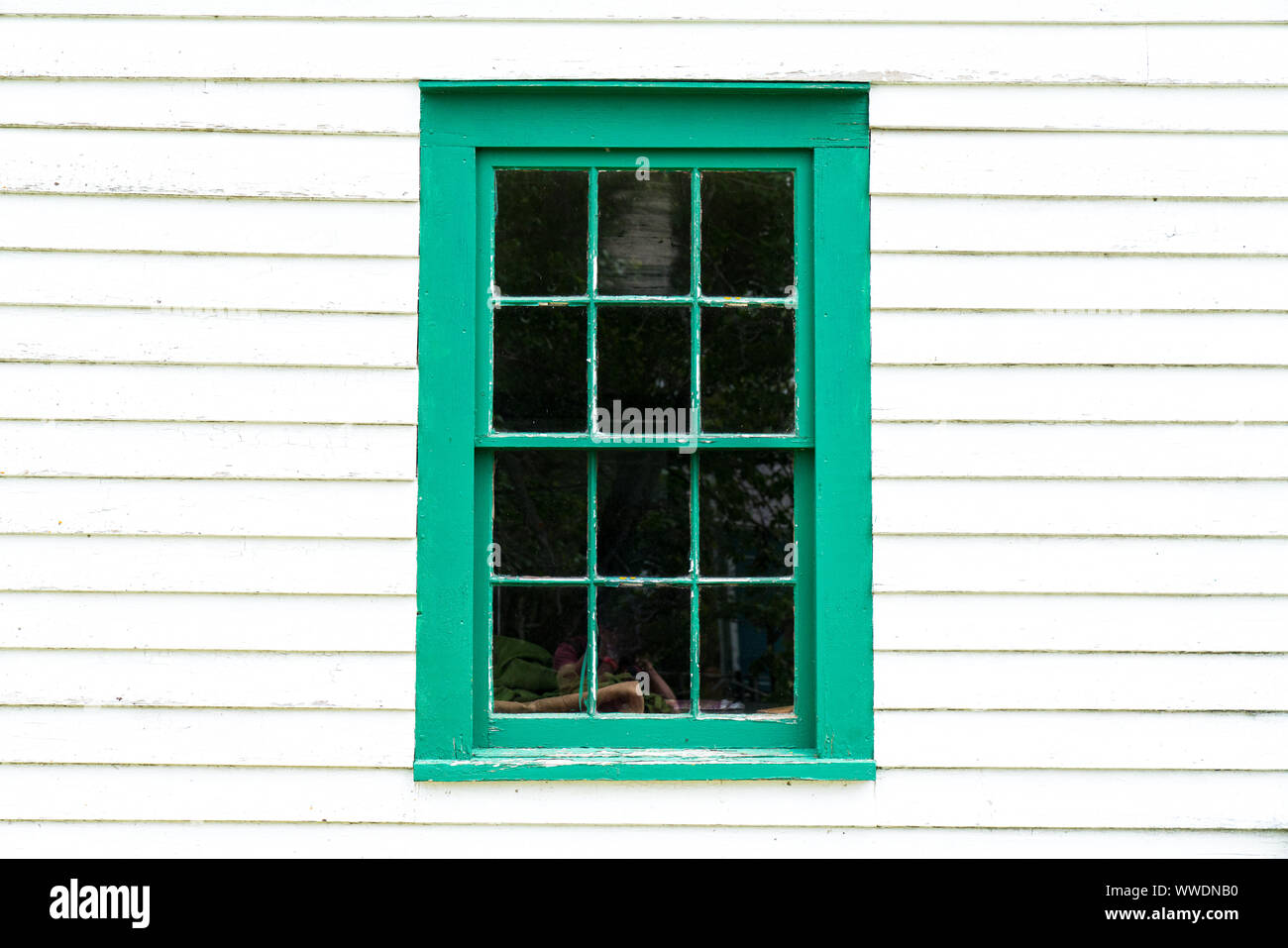 Old rustic green window frame on cedar shingles with weathered peeling Stock Photo