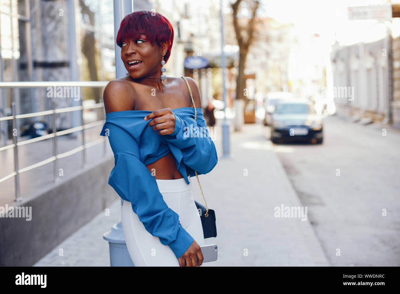 Beautiful And Stylish Dark Skinned Girl With Red Short Hair