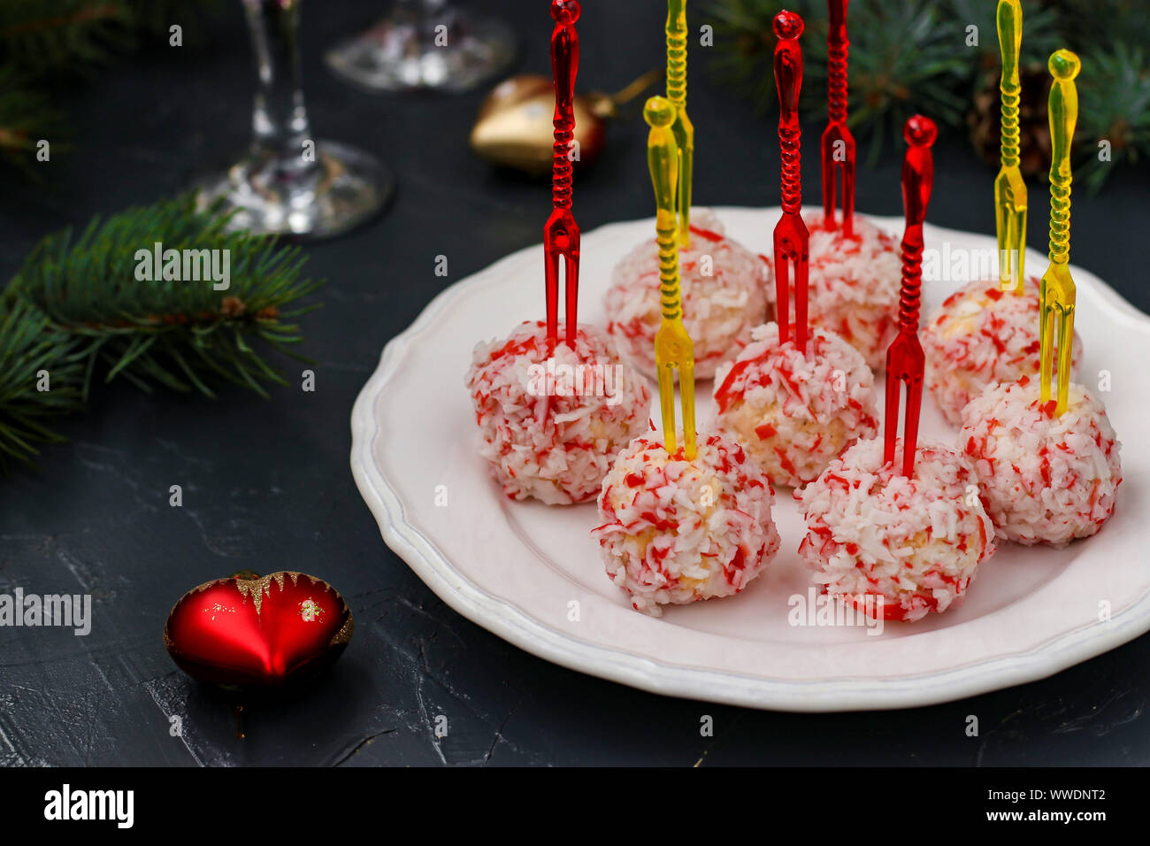 Cheese balls in crab shavings - a traditional snack for Christmas and New Year, horizontal orientation, closeup Stock Photo