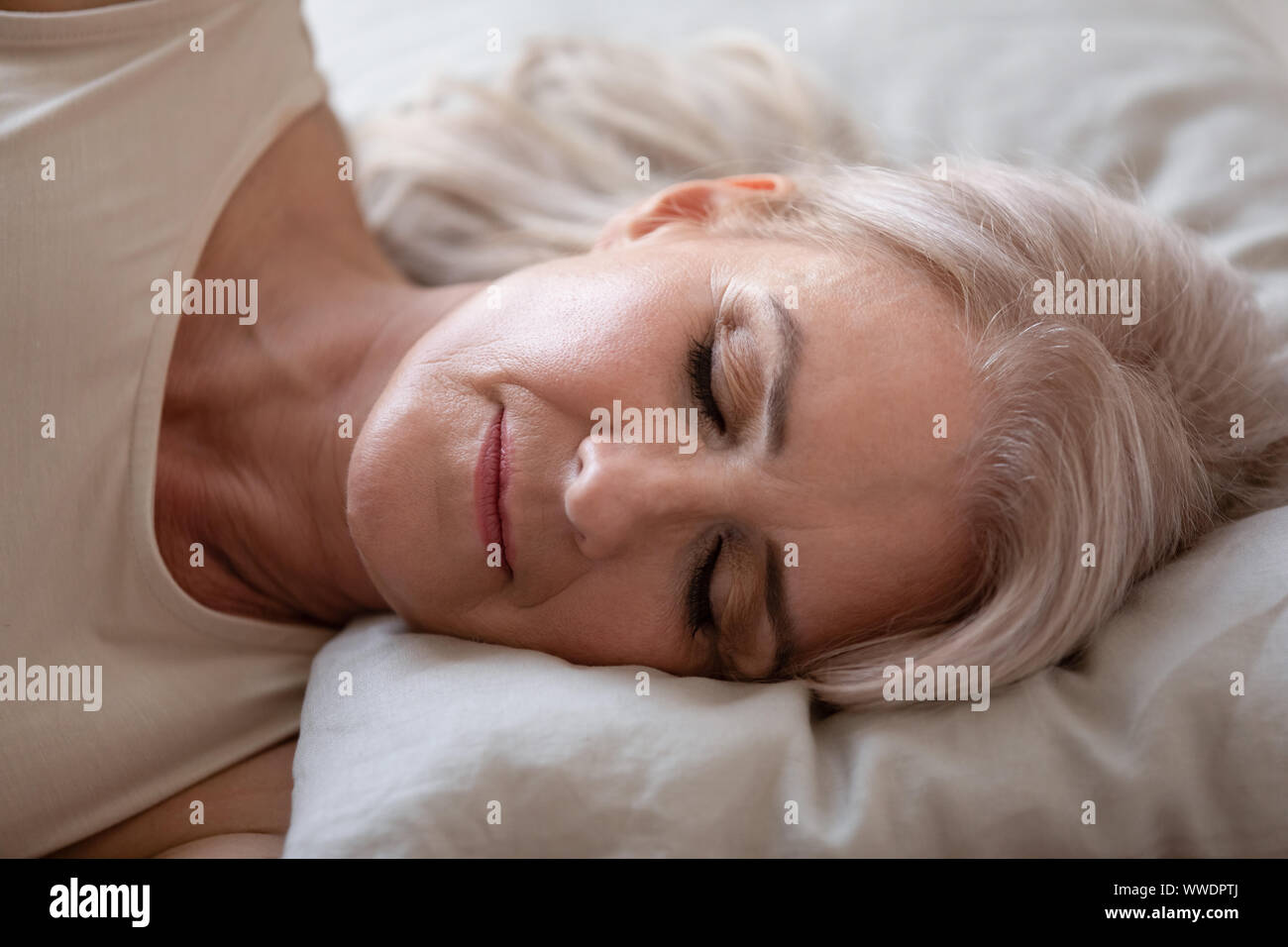 Mature woman sleeping bed hi-res stock photography and images - Alamy