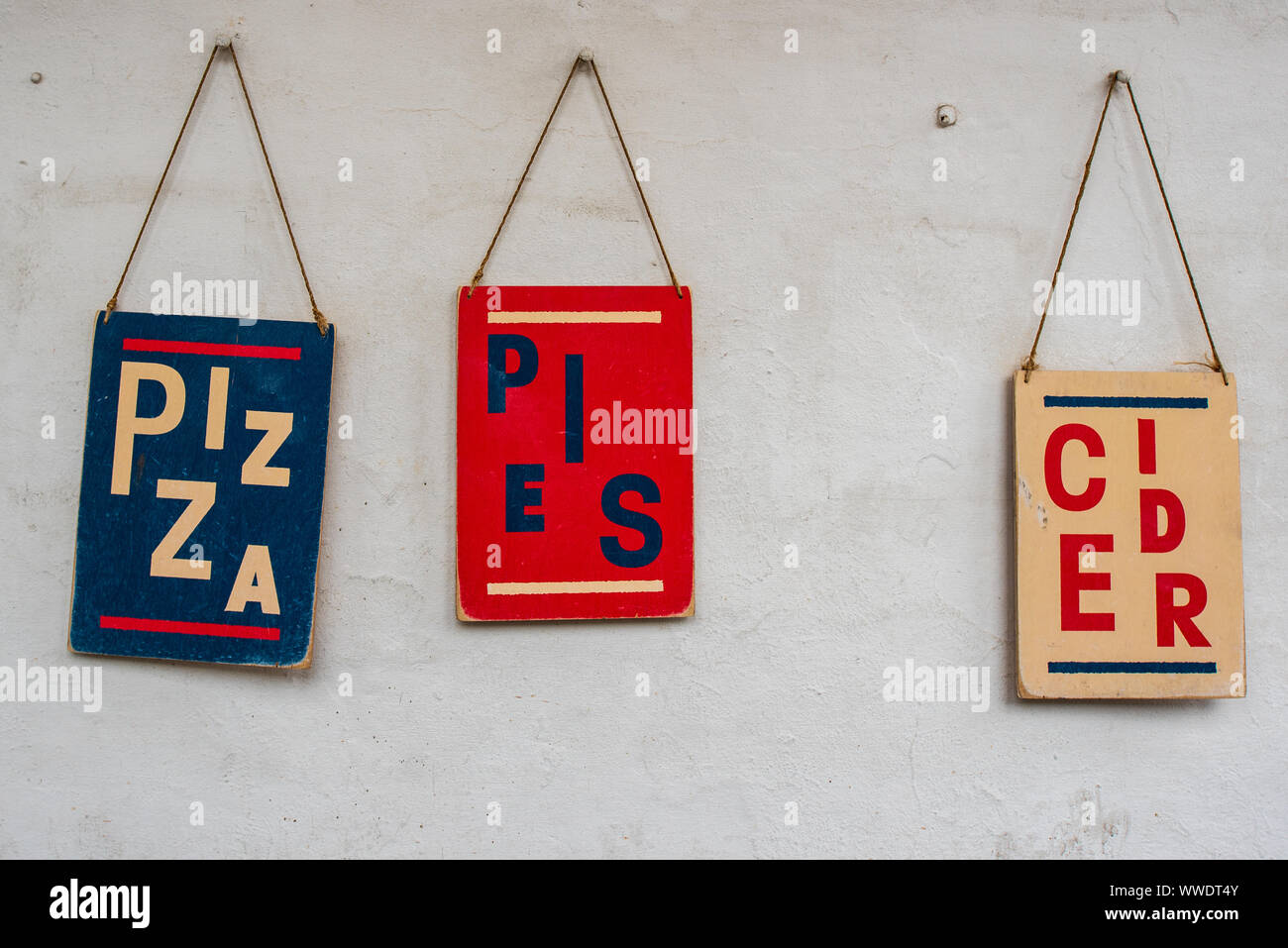 Pizza Pies and Cider - colourful signs outside the Falmouth Stable  restaurant and bar in the Old Customs House, Falmouth, Cornwall. Stock Photo