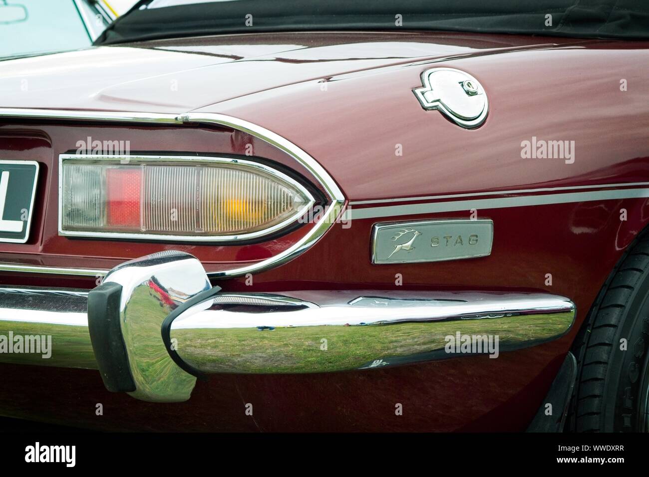 Right side rear quarter detail of a Triumph Stag classic British sports car showing chrome bumper, light cluster and Stag badge. Stock Photo