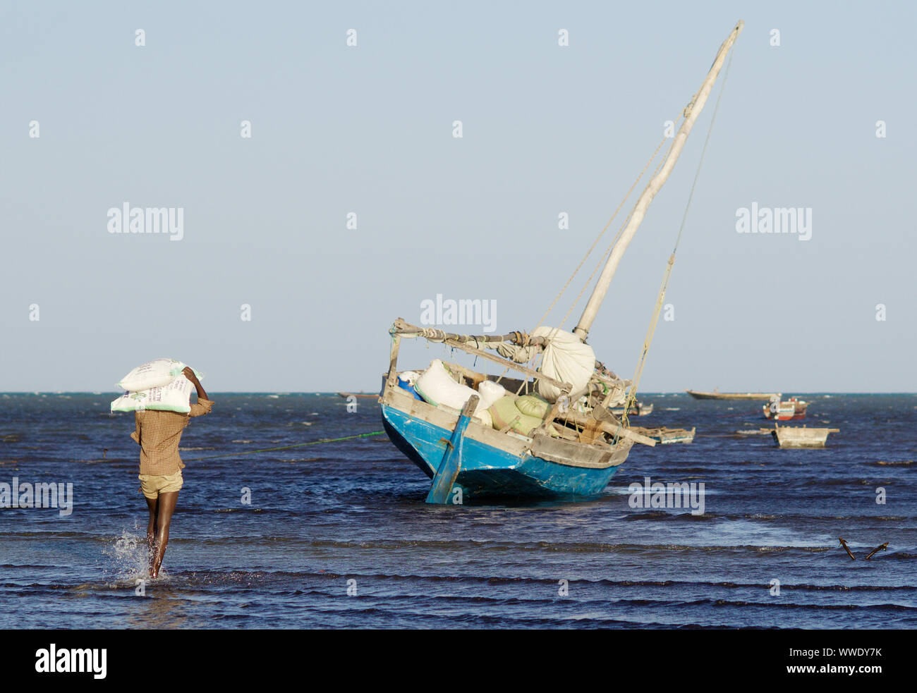 Sailer loading a dhow before sailing to Pemba island, Tanga surrounding, Tanzania Stock Photo