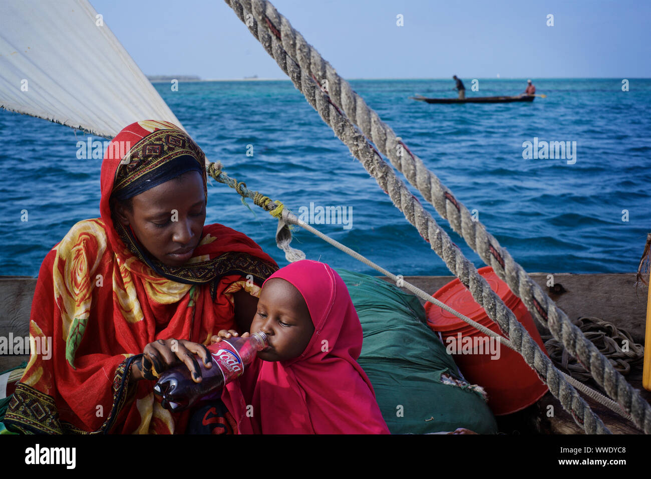 Swahili woman with veiled baby on dhow, Pemba island, Zanzibar Archipelago, Tanzania Stock Photo