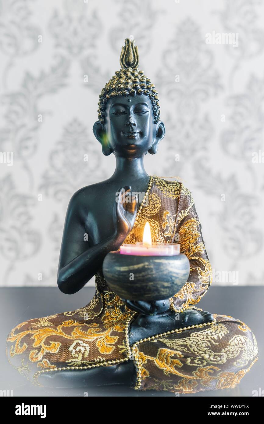 Budha  Statue with candle Stock Photo