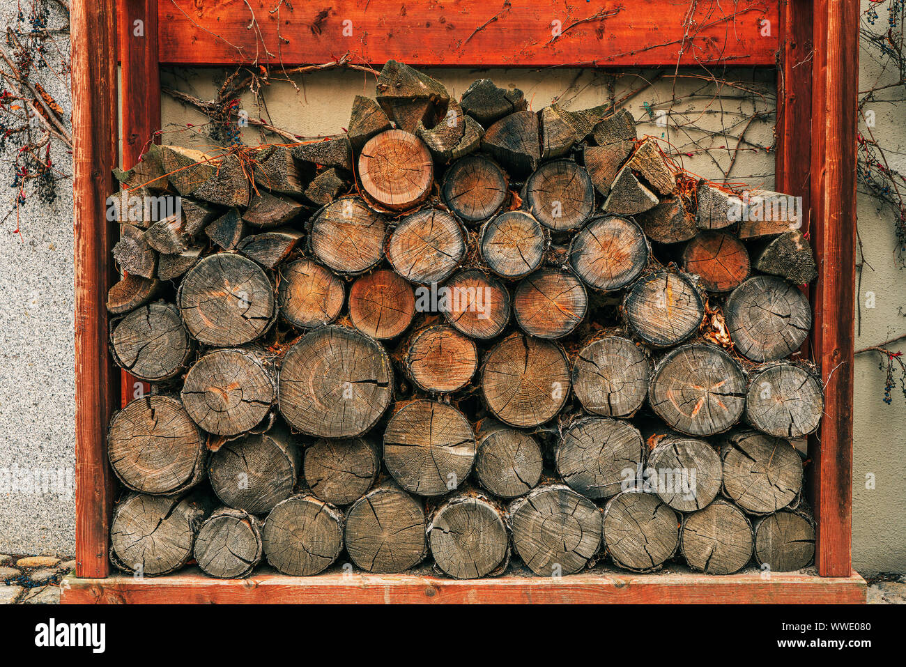firewood stacked on the wall Stock Photo