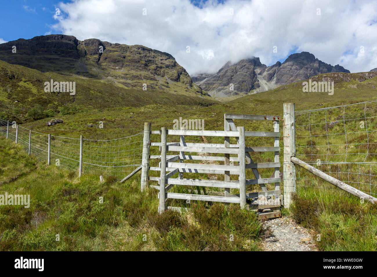 Tall kissing gate in deer fence on the footpath to Blaven in the Black Cuillin mountains on the Isle of Skye, Scotland, UK Stock Photo
