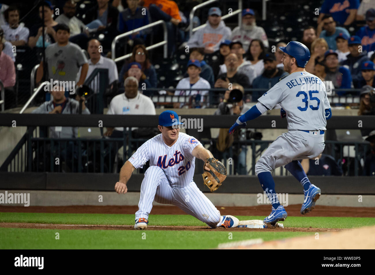 September 13, 2019: Los Angeles Dodgers right fielder Cody Bellinger (35) runs to beat out a ground ball at first base as New York Mets first baseman Pete Alonso (20) receives the ball during the game between The New York Mets and The Los Angeles Dodgers at Citi Field in Queens, New York. Mandatory credit: Kostas Lymperopoulos/CSM Stock Photo