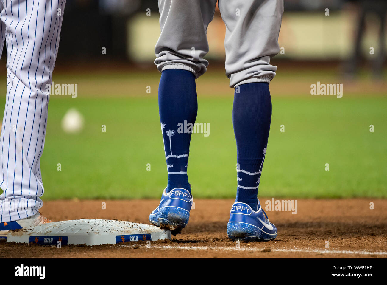 Queens, New York, USA. 13th Sep, 2019. Los Angeles Dodgers right fielder  Cody Bellinger (35) has ''Poppy'' written on the back of his cleats and palm  trees on his socks during the