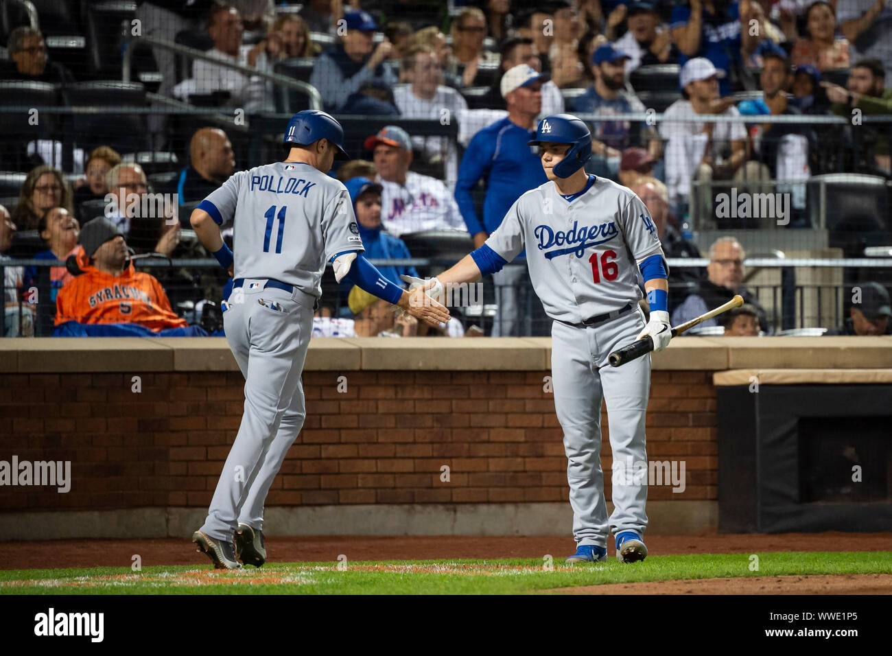 Queens, New York, USA. 13th Sep, 2019. Los Angeles Dodgers center fielder A.J. Pollock (11) celebrates with Los Angeles Dodgers catcher Will Smith (16) after scoring a run during the game between The New York Mets and The Los Angeles Dodgers at Citi Field in Queens, New York. Mandatory credit: Kostas Lymperopoulos/CSM/Alamy Live News Stock Photo