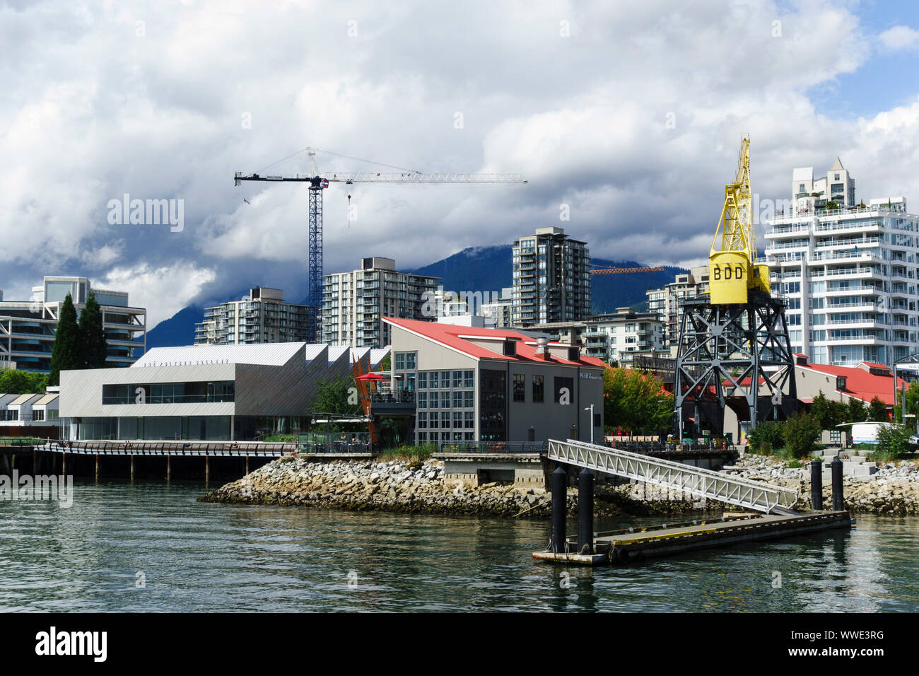 Lonsdale waterfront with Polygon Gallery, Pier 7 restaurant and historic crane. North Vancouver, British Columbia, Canada. Stock Photo
