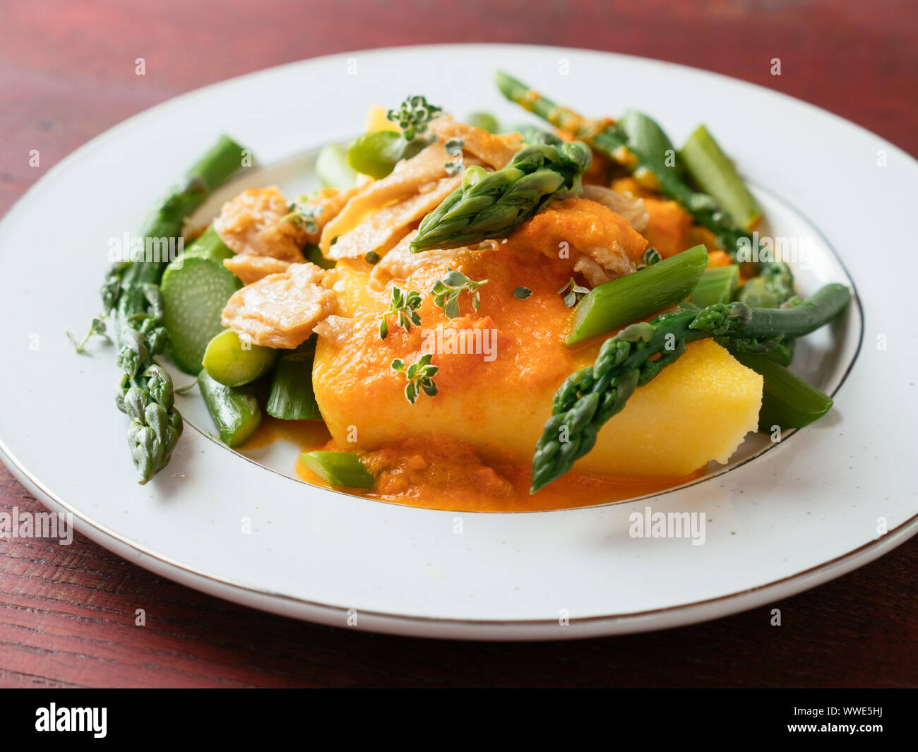 Polenta with Asparagus, Vegan Chickun and a Creamy Bell Pepper Sauce Stock Photo