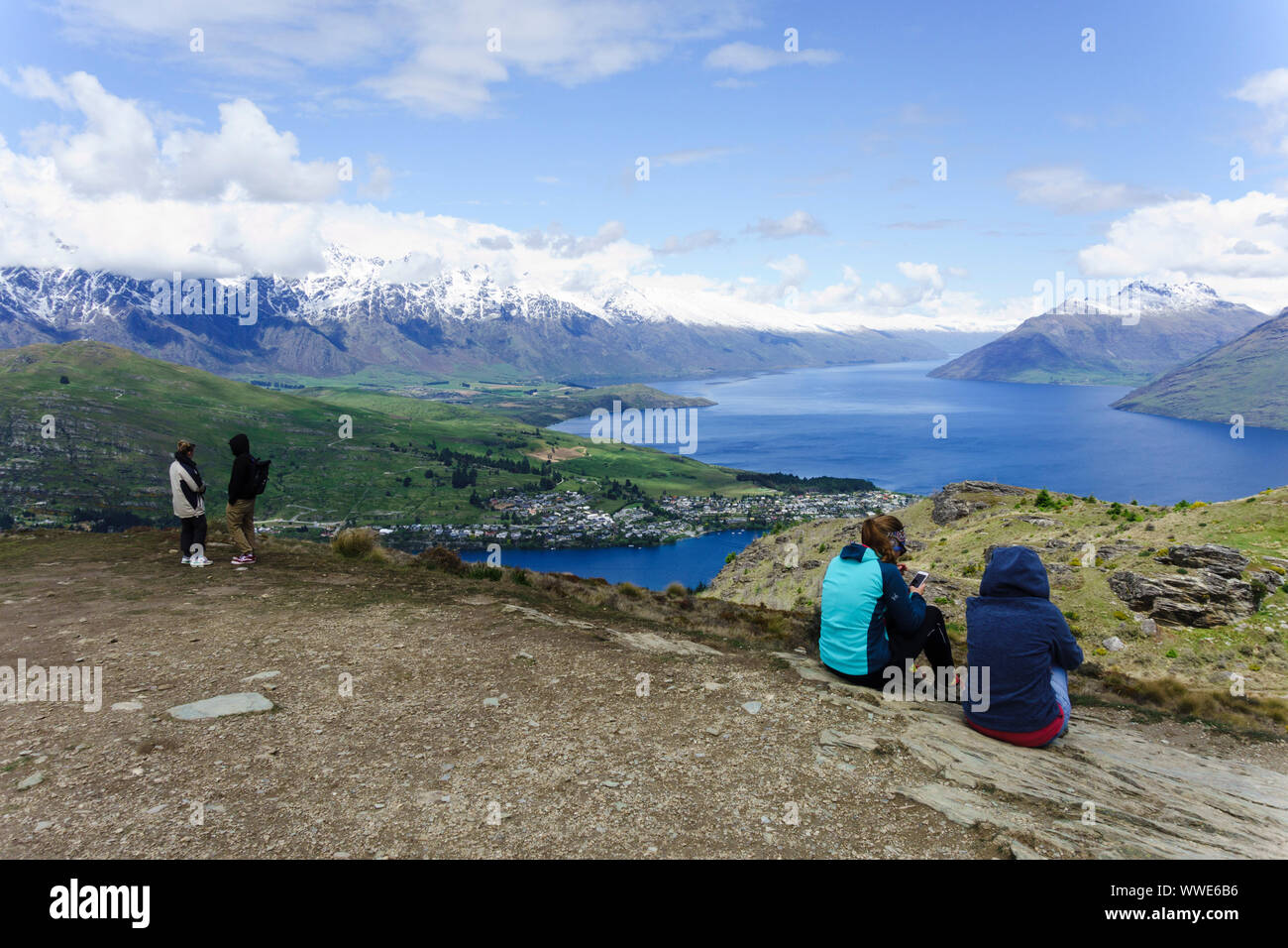 People enjoying the view over Lake Wakatipu from Queenstown Hill. Queenstown, Otago, New Zealand. Stock Photo
