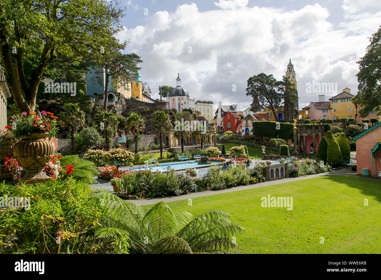 Portmeirion, UK: September 01, 2019: The gardens at the centre of Portmeirion village with flowers, ornate pond and Italian style hotel accomodation. Stock Photo