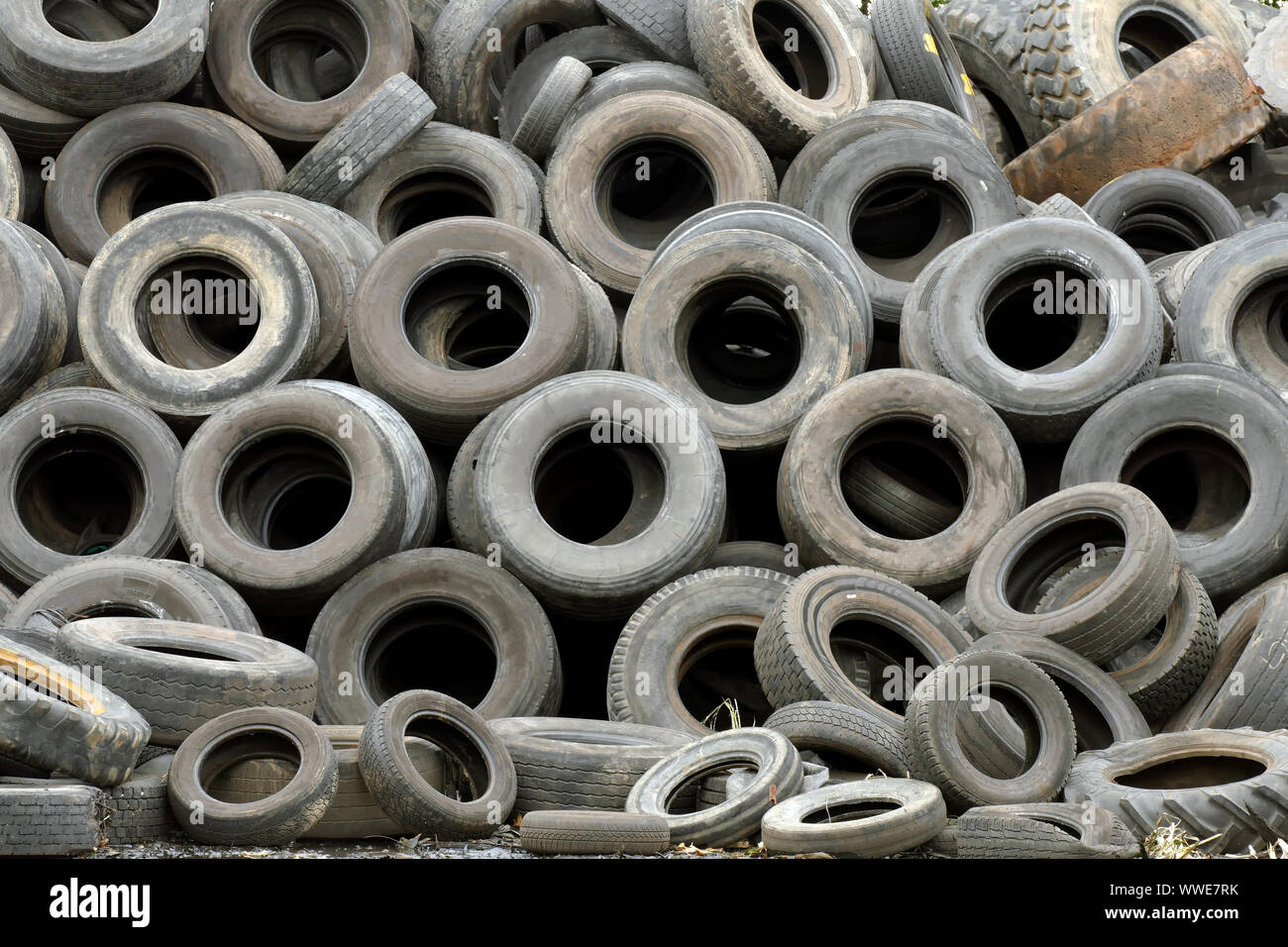 Wheel worn wear rubber tyre junkyard recycling heap hires stock