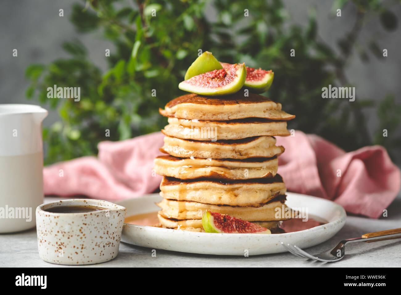 Pancakes with syrup and figs on top. Tasty breakfast. Stack of fluffy ...