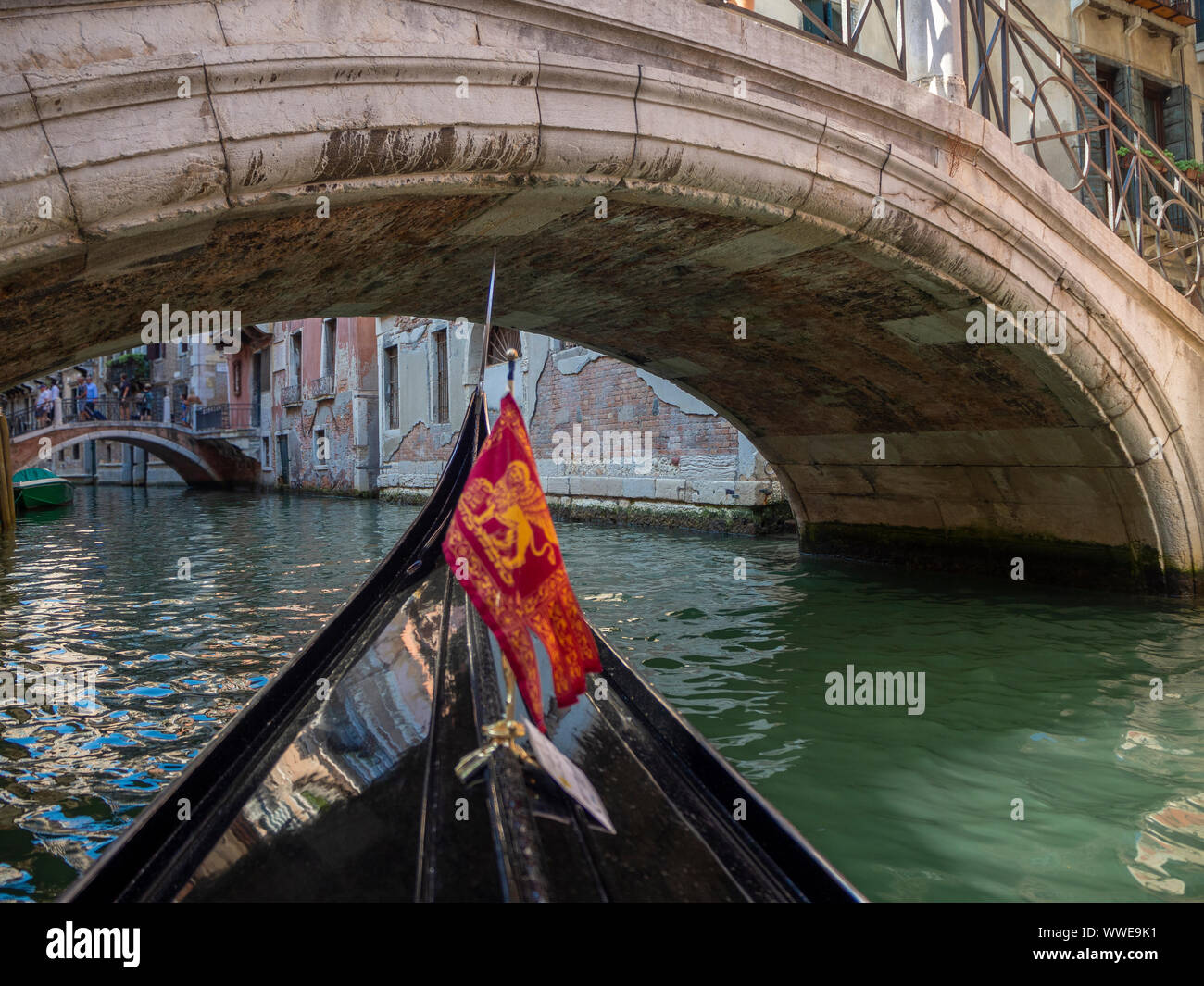 POV Gondola ride under a bridge through the canals of Venice Stock Photo