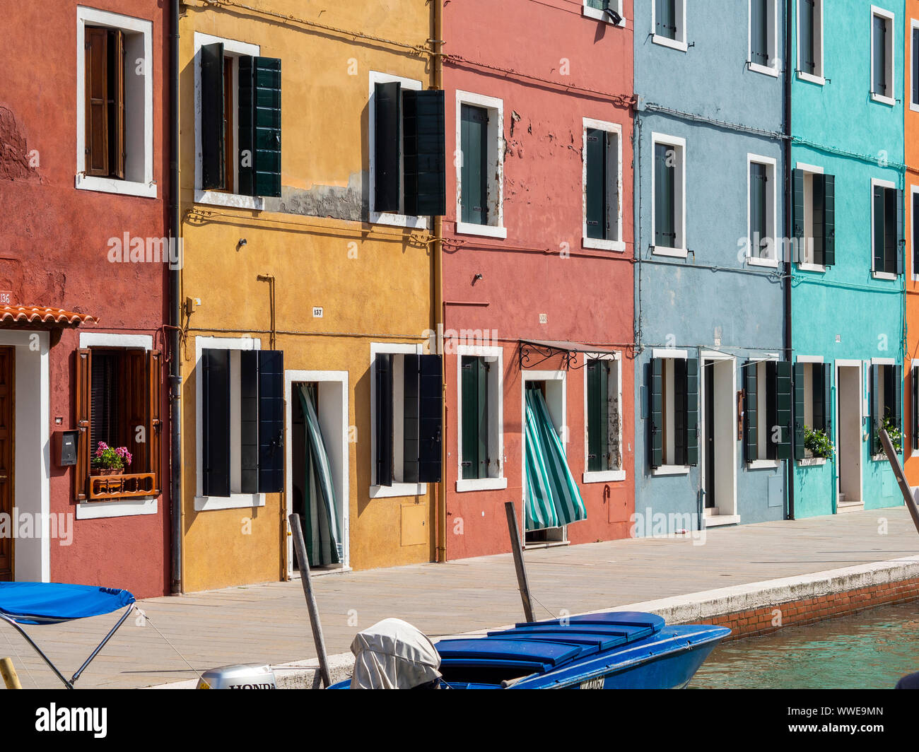 Colorful houses near canal on Burano island, Venice, Italy. Burano is a