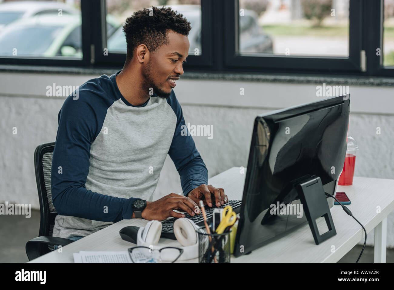 handsome african american programmer working on computer in office Stock Photo