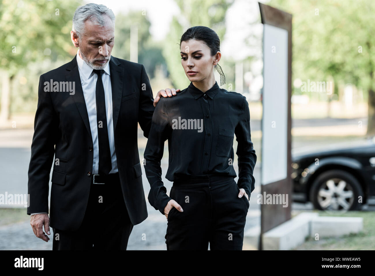 upset senior man and sad beautiful woman in formal wear near car Stock ...