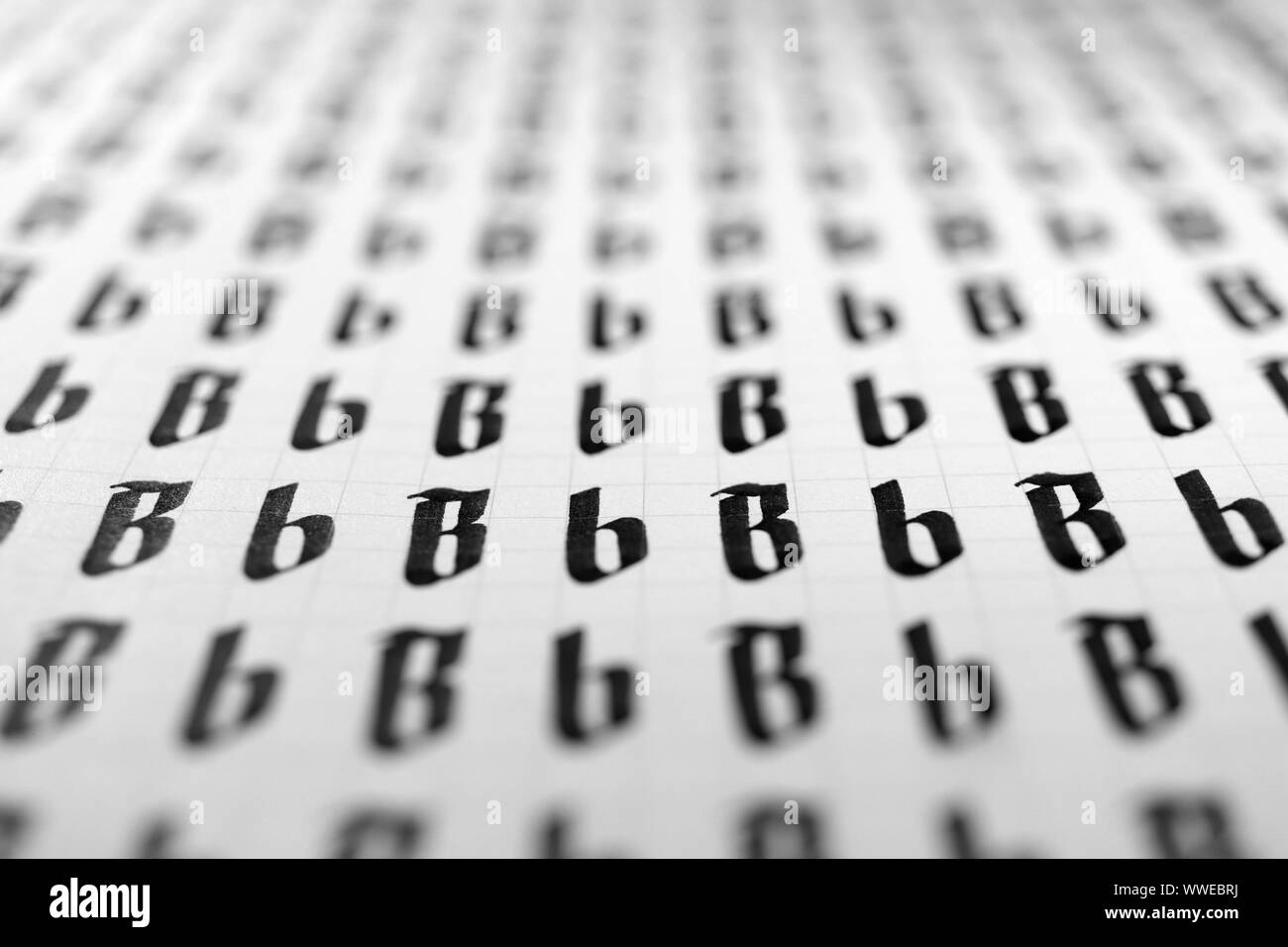 Calligraphy black and white letters B background. Lettering practice writing worksheet. Handwriting symbol filling pattern. Calligraphic letter B lear Stock Photo