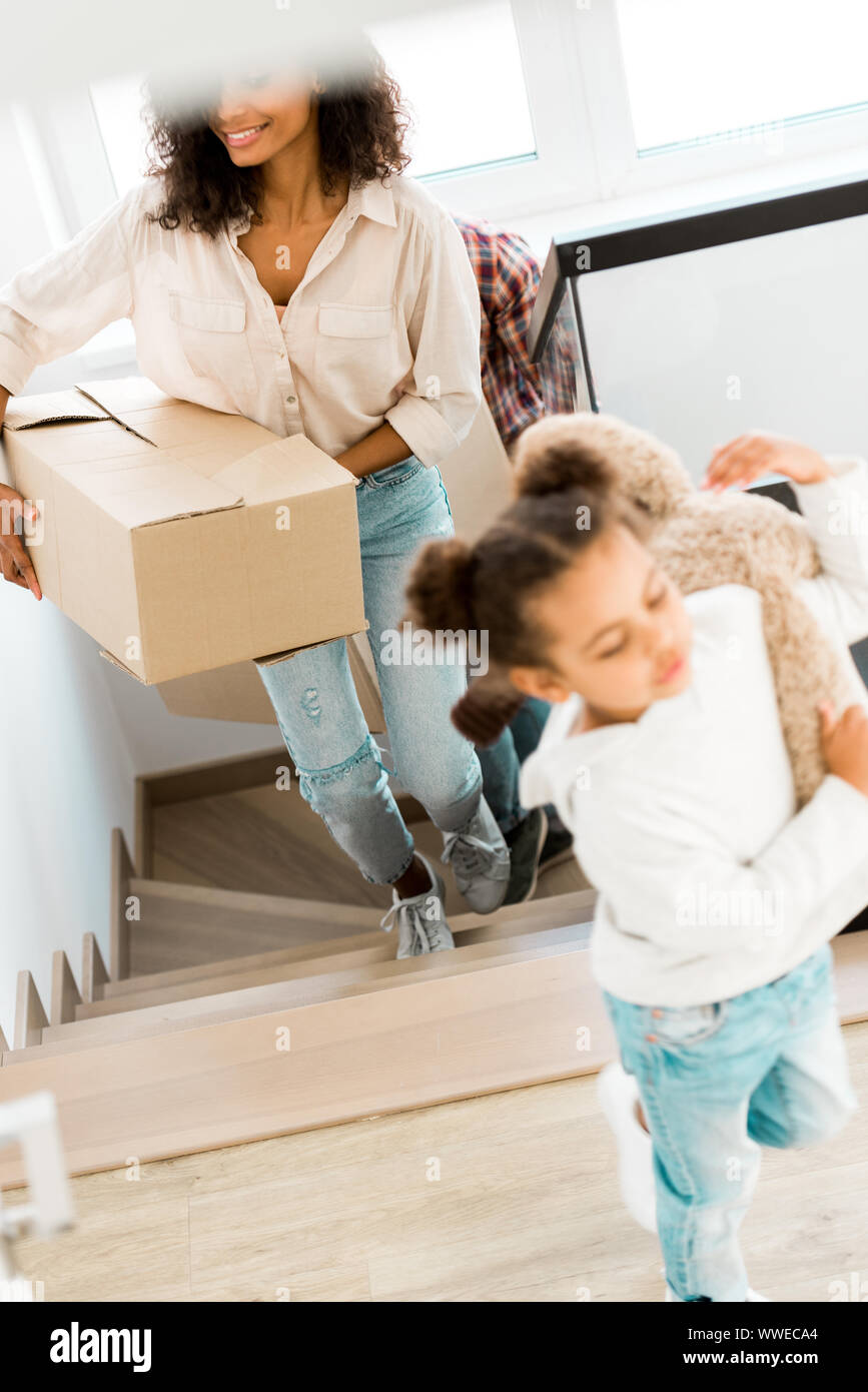 selective focus of african american mother going upstairs while kid