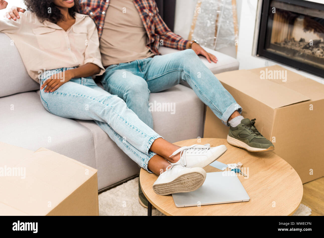cropped view of african american wife and husband relaxing while ...