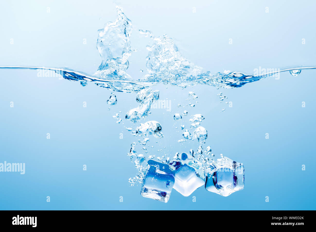 pure water with splash, bubbles and ice cubes on blue background Stock ...