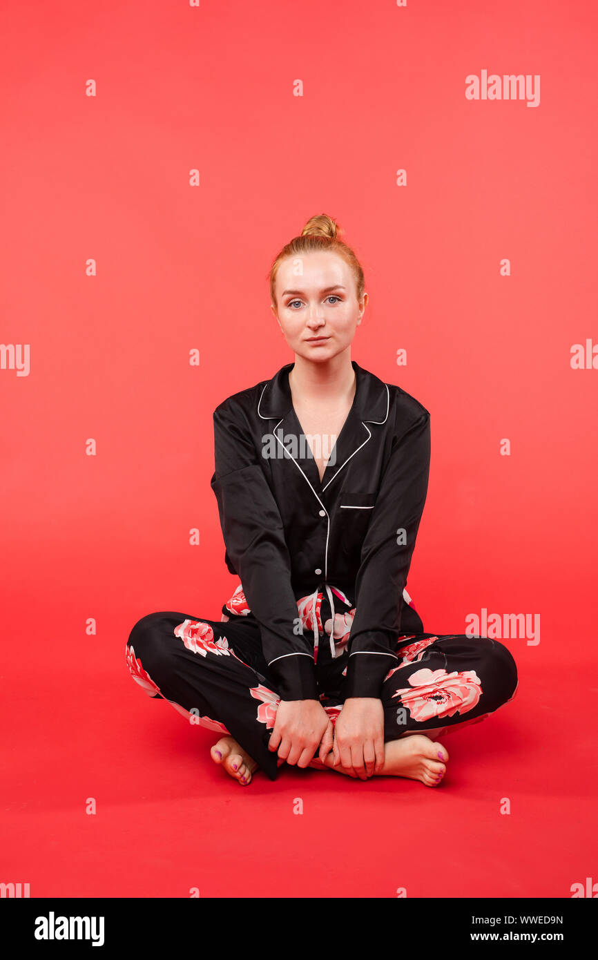 Young girl sitting on floor and meditating with closed eyes Stock Photo ...
