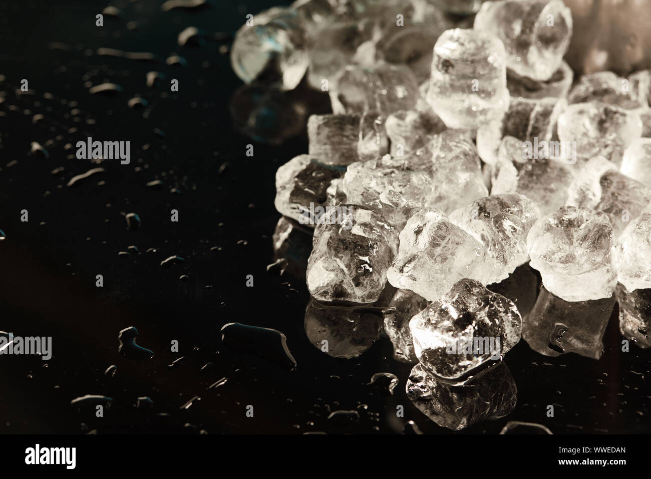 stack of transparent cool ice cubes on black background with water ...