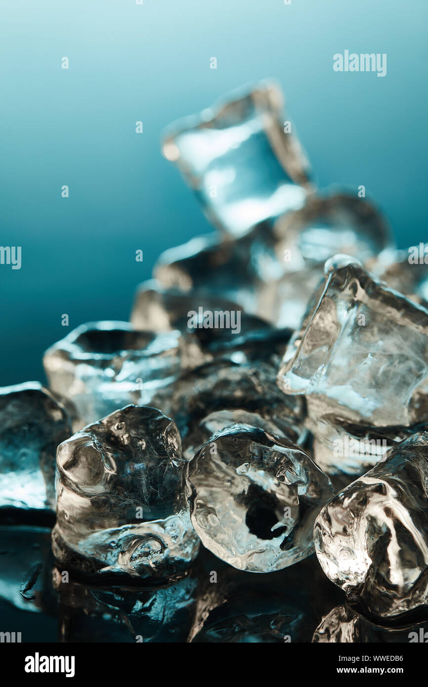 selective focus of transparent ice cubes on emerald background Stock ...