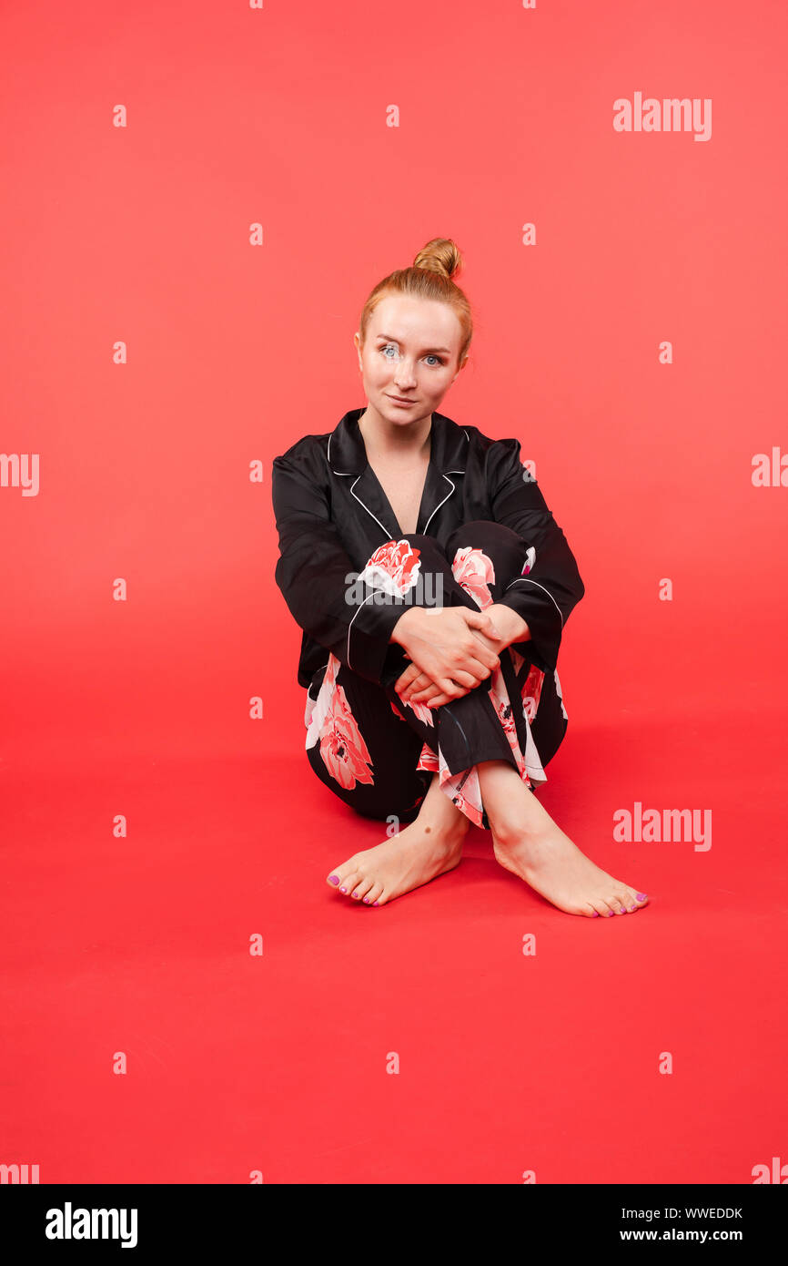 Young girl sitting on floor and meditating with closed eyes Stock Photo ...