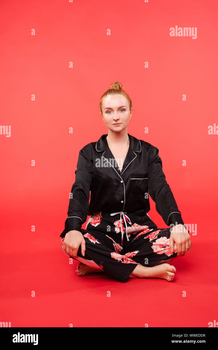 Young girl sitting on floor and meditating with closed eyes Stock Photo ...