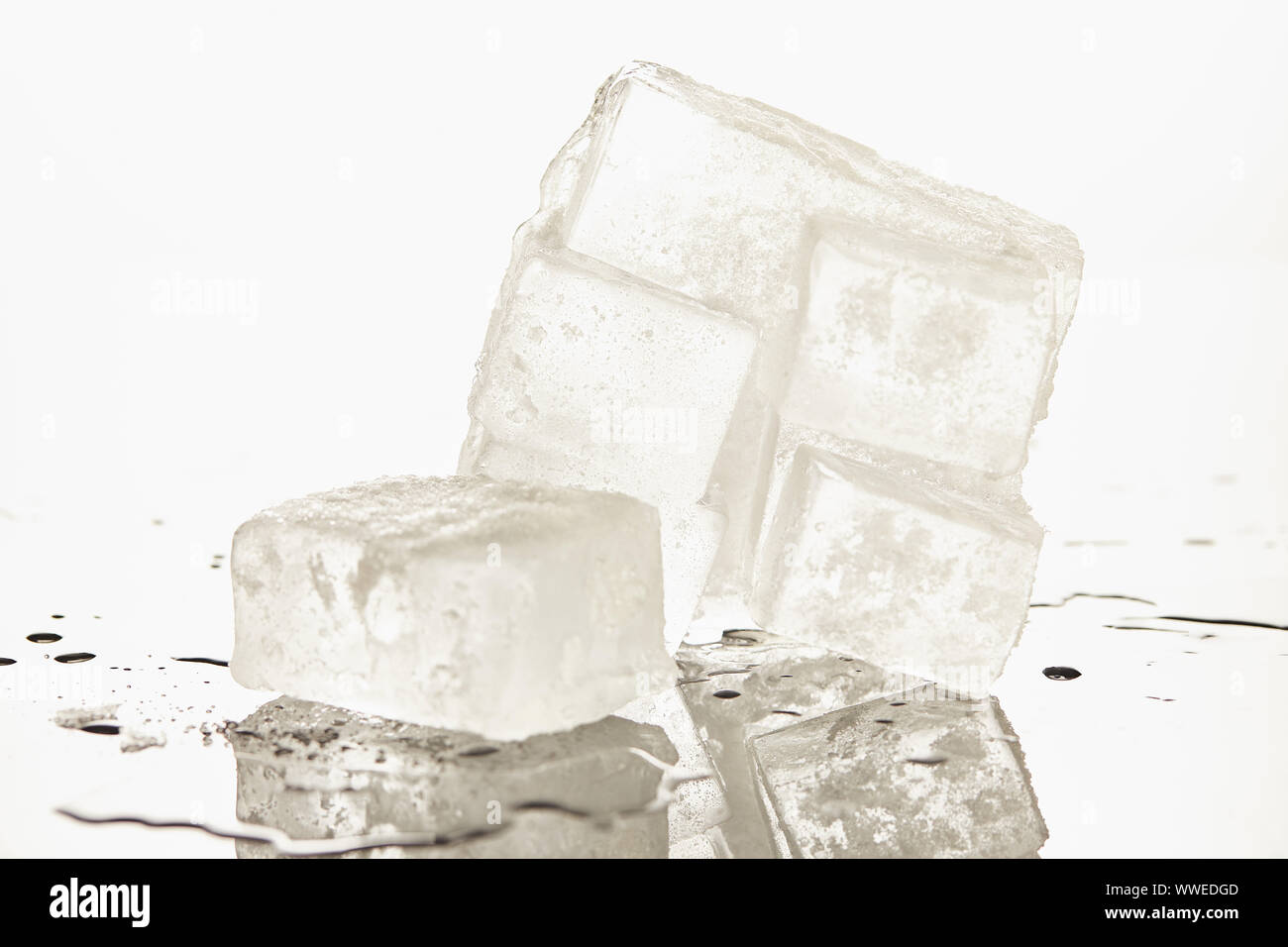 A Large Rectangle Of Melting Clear Ice On White Background With A