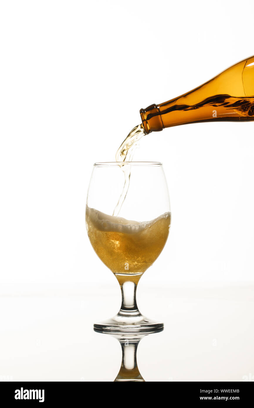 beer pouring from bottle into glass isolated on white Stock Photo Alamy
