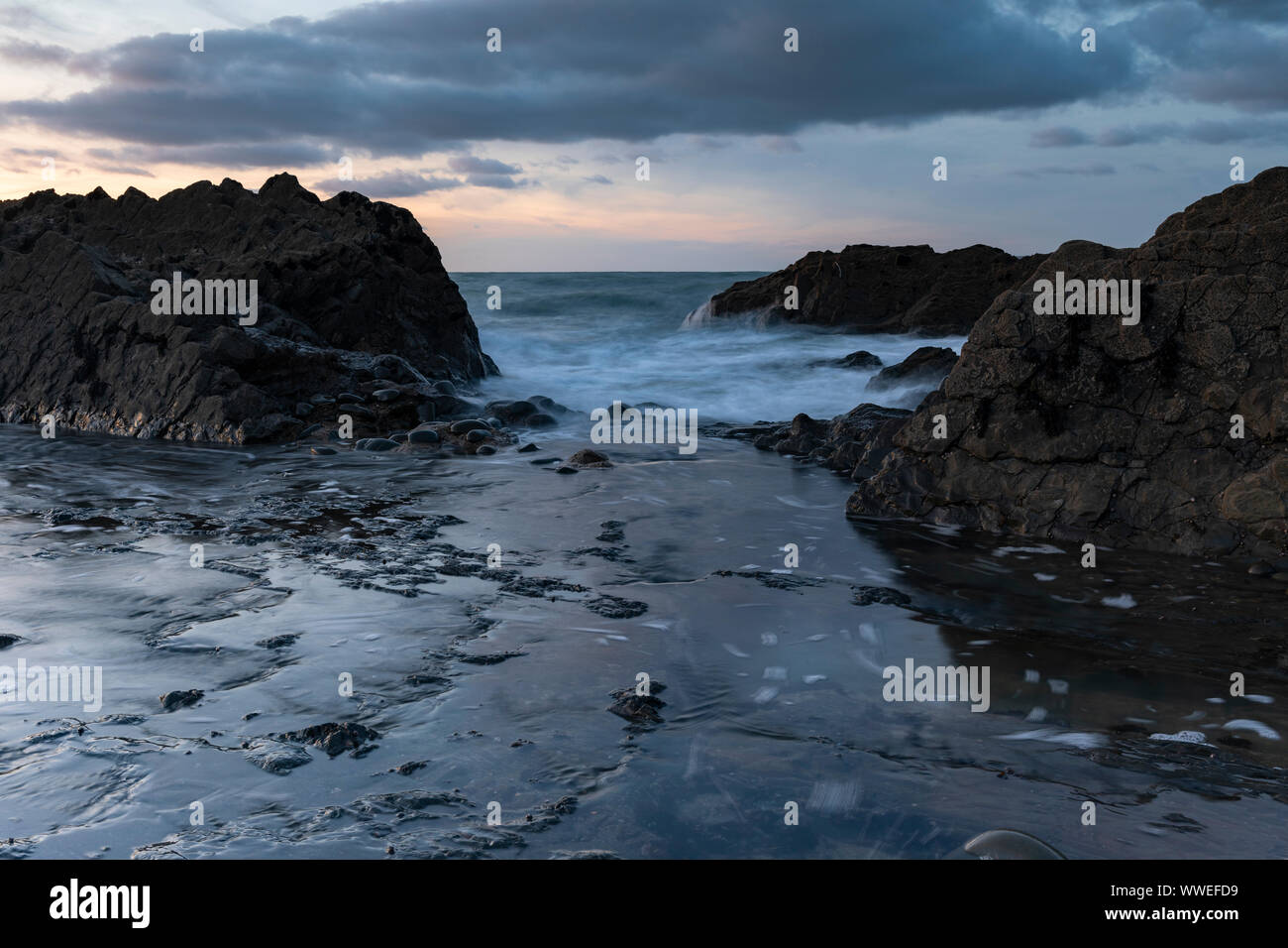 seascape view of westward ho in north devon with waves crashing over rocks Stock Photo