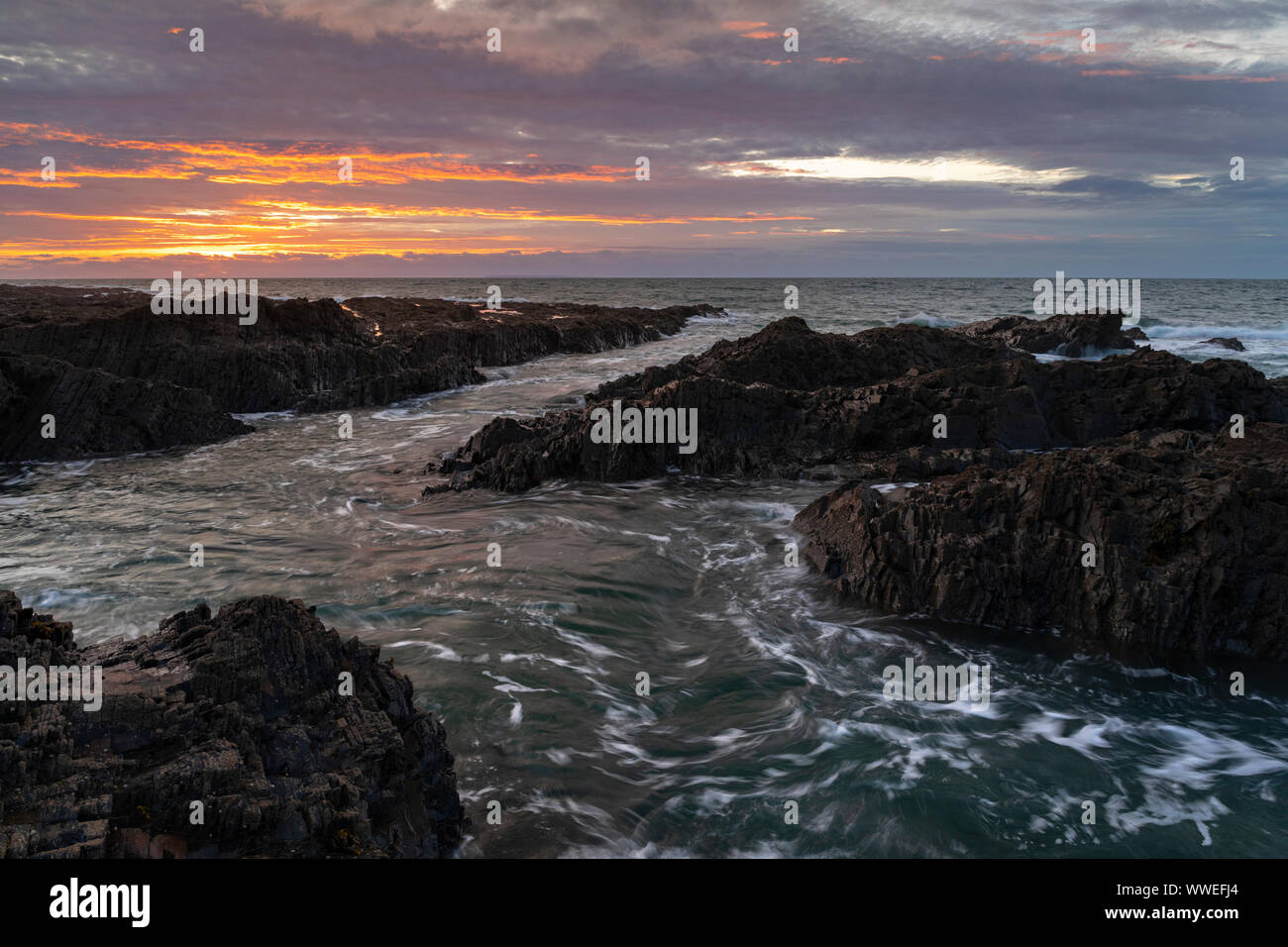 seascape view of westward ho in north devon with waves crashing over rocks Stock Photo