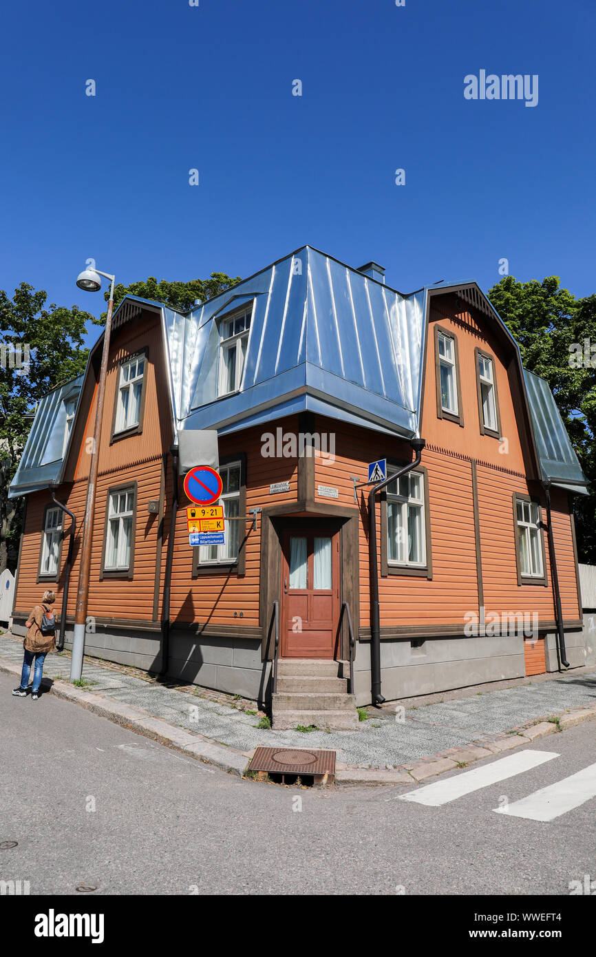 Old wooden building with shiny new metal roof on the corner of Virtaintie and Suvannontie in Helsinki, Finland Stock Photo